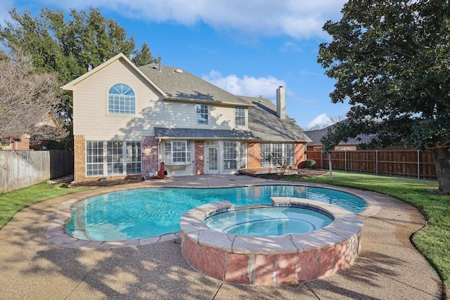 view of swimming pool featuring a patio area and an in ground hot tub