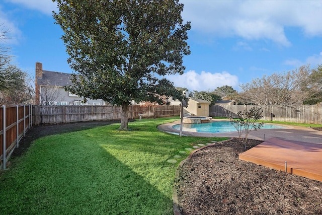 view of yard with a storage shed and a swimming pool side deck