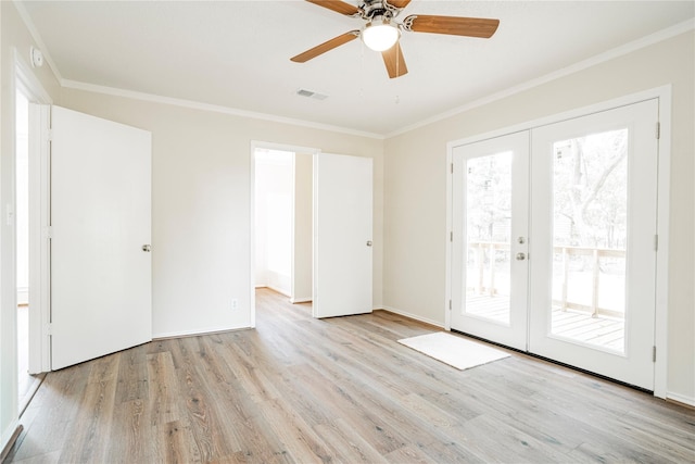 spare room with light hardwood / wood-style flooring, ornamental molding, and french doors