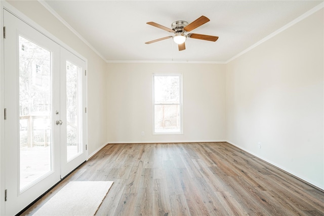 spare room with crown molding, light hardwood / wood-style flooring, ceiling fan, and french doors