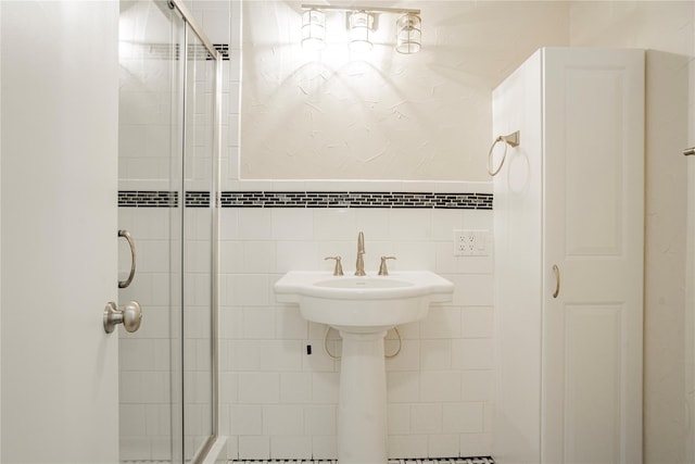 bathroom with tile walls and walk in shower