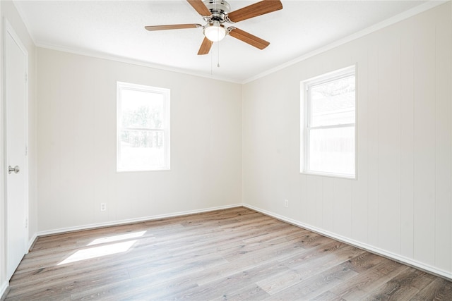 spare room with ceiling fan, ornamental molding, plenty of natural light, and light hardwood / wood-style flooring