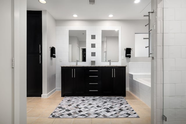 bathroom with a sink, a bath, tile patterned floors, double vanity, and a stall shower