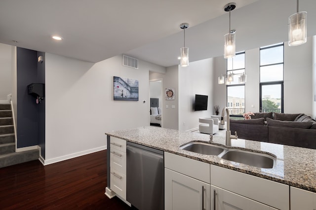 kitchen featuring visible vents, dark wood-type flooring, a sink, light stone countertops, and dishwasher