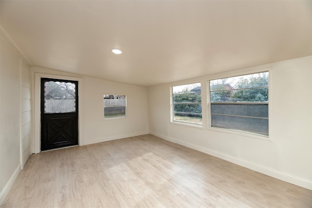 interior space featuring vaulted ceiling and light hardwood / wood-style flooring