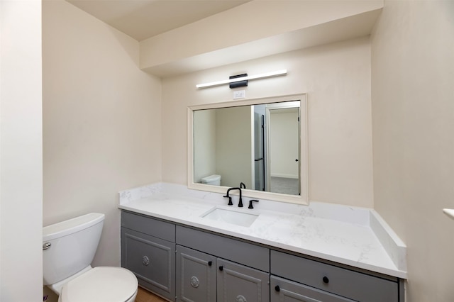 bathroom with vanity and toilet