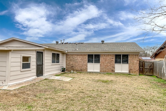 rear view of house featuring a yard