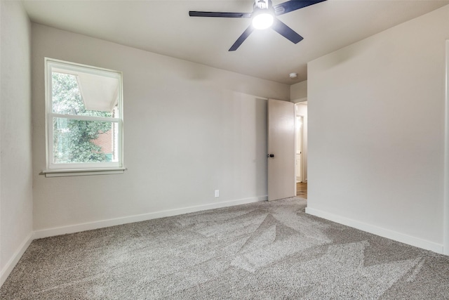 carpeted empty room featuring ceiling fan