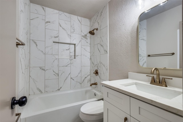 full bathroom featuring tiled shower / bath, vanity, and toilet