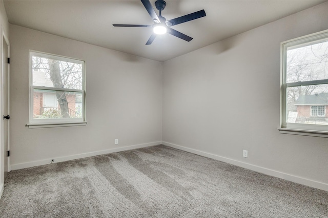 carpeted spare room featuring ceiling fan