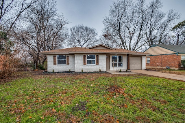 ranch-style home with a garage and a front lawn