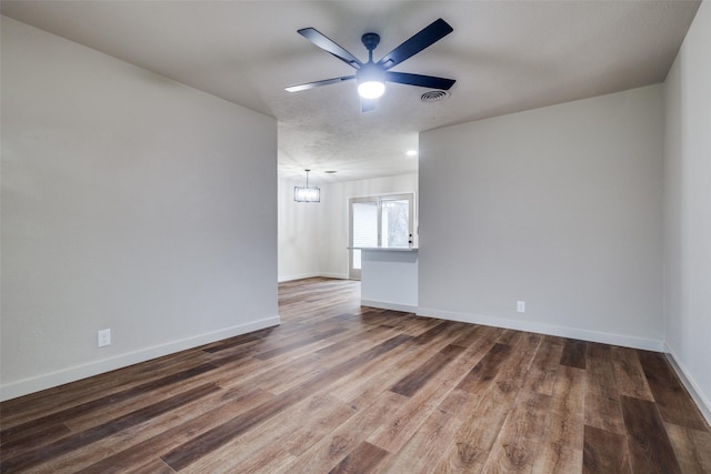 spare room featuring a textured ceiling, dark hardwood / wood-style floors, and ceiling fan