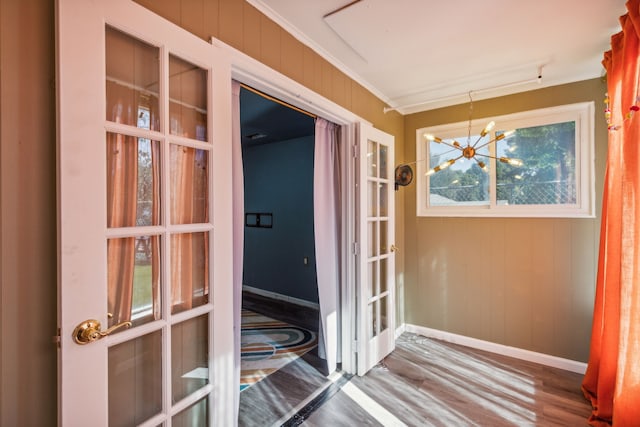 unfurnished sunroom with a notable chandelier and french doors