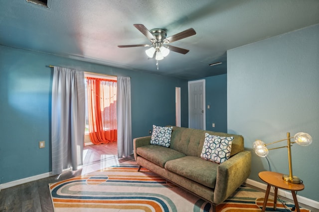 living room featuring hardwood / wood-style flooring and ceiling fan