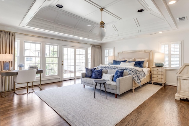 bedroom featuring multiple windows, crown molding, dark hardwood / wood-style floors, and access to exterior