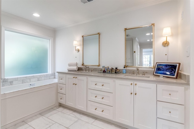 bathroom featuring ornamental molding, vanity, and a tub