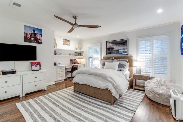 bedroom featuring ornamental molding, wood-type flooring, and ceiling fan