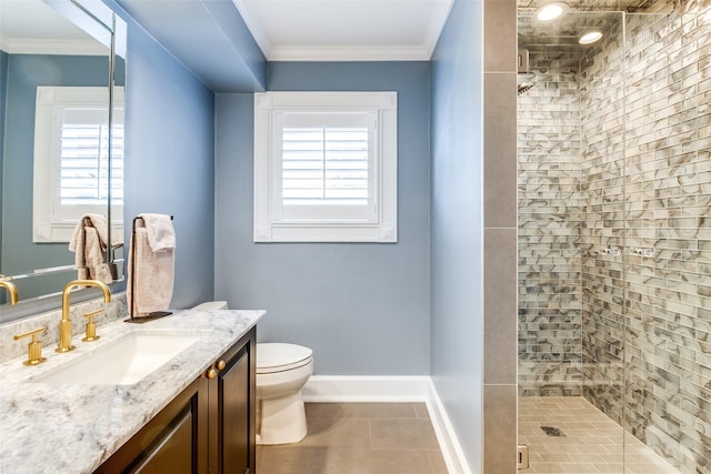 bathroom with ornamental molding, a wealth of natural light, vanity, and a tile shower