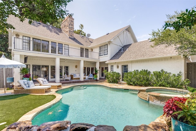 view of pool featuring an in ground hot tub and a patio area