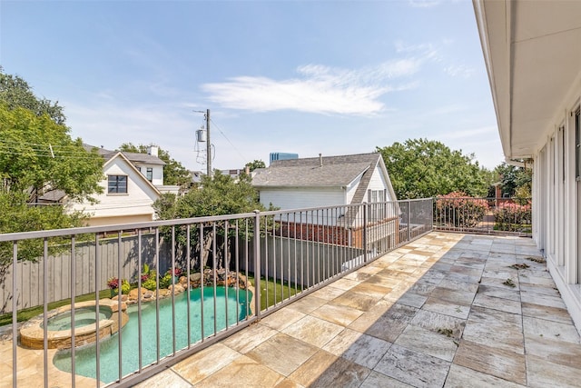 view of patio with a pool with hot tub and a balcony