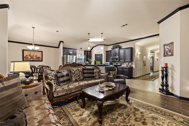 living room featuring ornamental molding and a chandelier