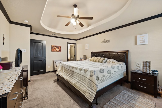 bedroom featuring light carpet, crown molding, a raised ceiling, and ceiling fan