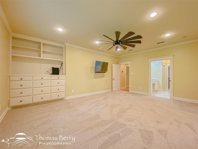 unfurnished bedroom featuring light colored carpet, ornamental molding, and ensuite bathroom