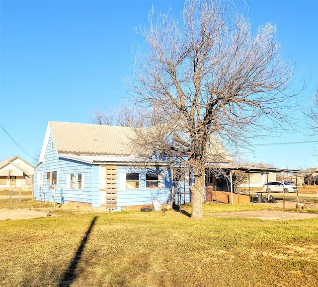 exterior space featuring a front yard and a carport