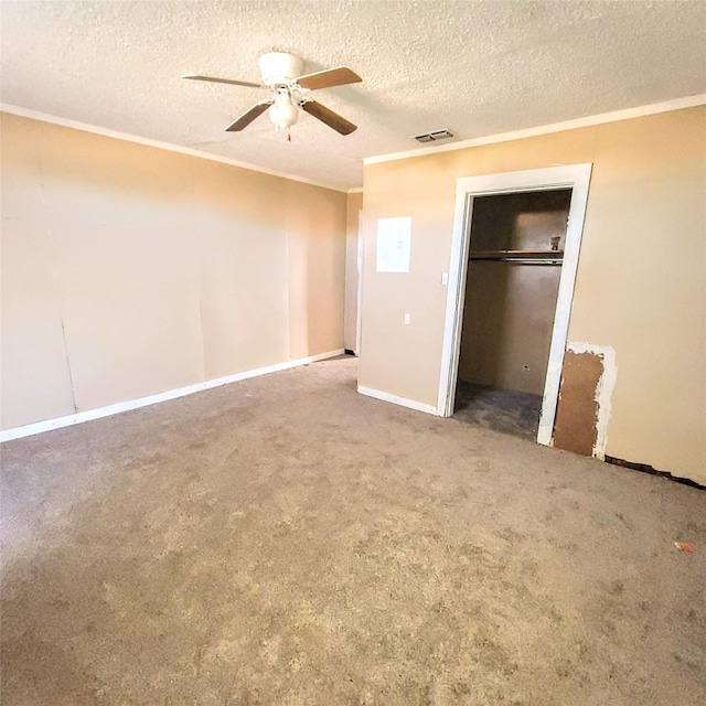 unfurnished bedroom featuring ceiling fan, carpet flooring, ornamental molding, a textured ceiling, and a closet