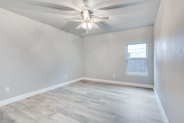 empty room with ceiling fan and light hardwood / wood-style flooring