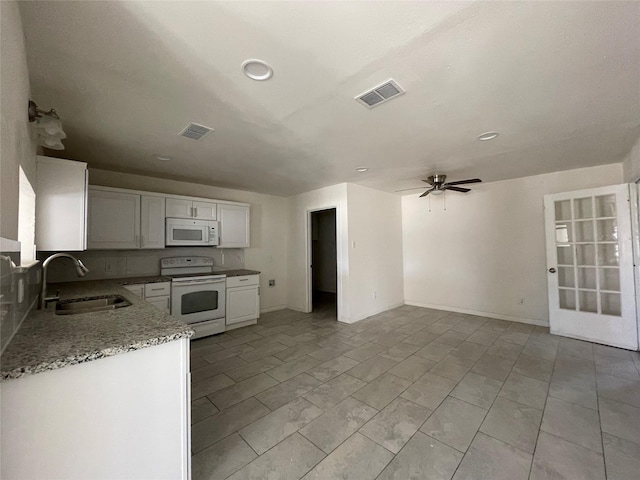 kitchen featuring sink, white appliances, ceiling fan, backsplash, and white cabinets