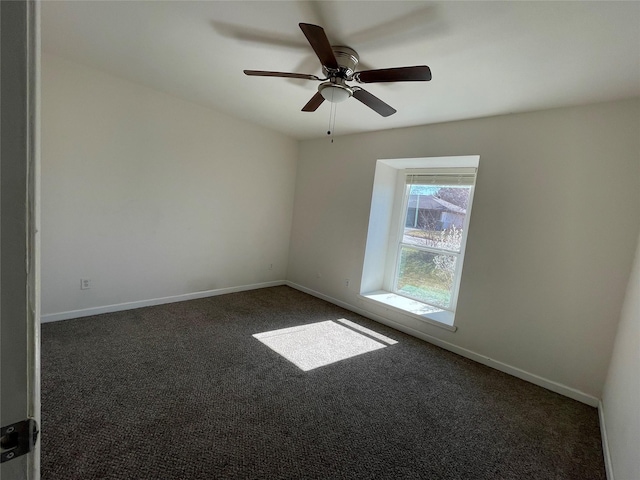 carpeted spare room featuring ceiling fan