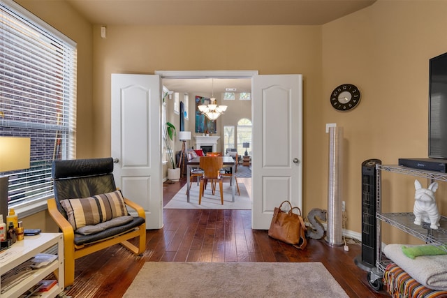 living area featuring dark hardwood / wood-style floors and a chandelier