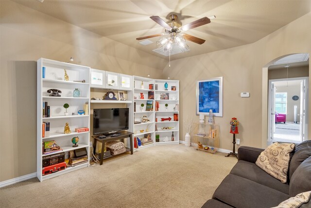 office with vaulted ceiling and light colored carpet