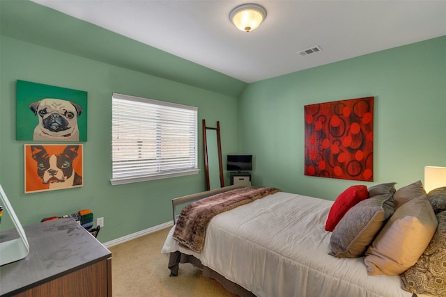 carpeted bedroom with lofted ceiling