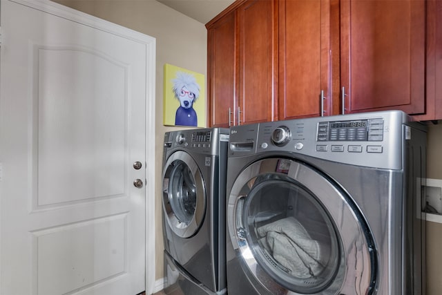 laundry area with cabinets and washer and clothes dryer