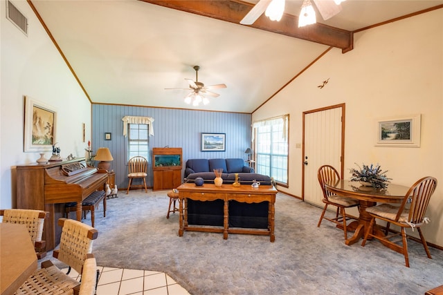 living room with beamed ceiling, crown molding, light colored carpet, and ceiling fan