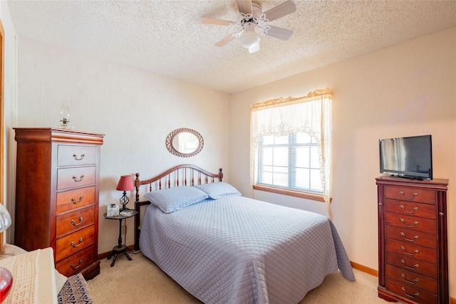 carpeted bedroom featuring a textured ceiling and ceiling fan