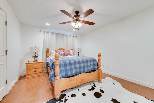 bedroom with ceiling fan and light hardwood / wood-style floors