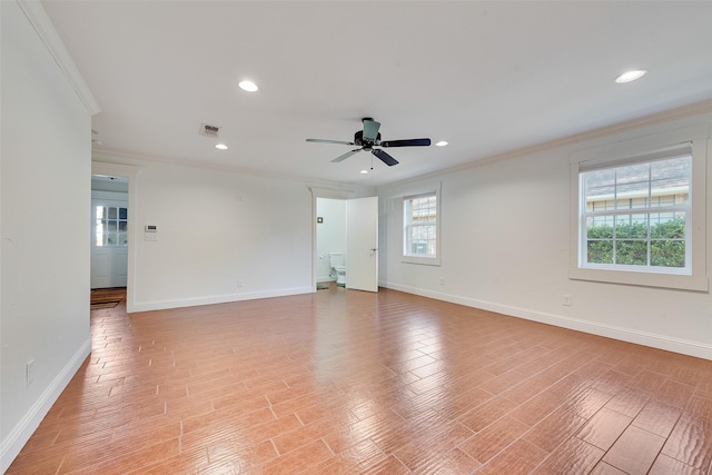 empty room featuring light hardwood / wood-style flooring, ornamental molding, and ceiling fan