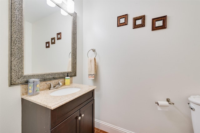 bathroom featuring vanity and toilet