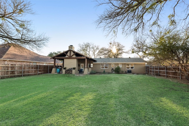 back of house with a lawn