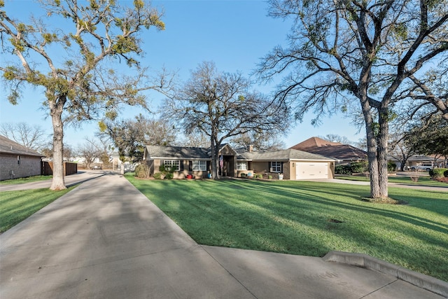 single story home featuring a garage and a front lawn