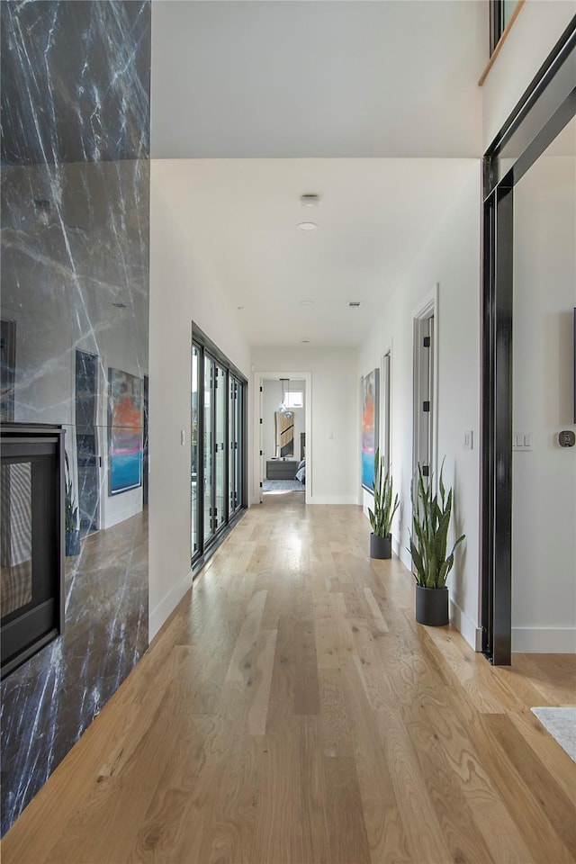 hallway with light hardwood / wood-style floors