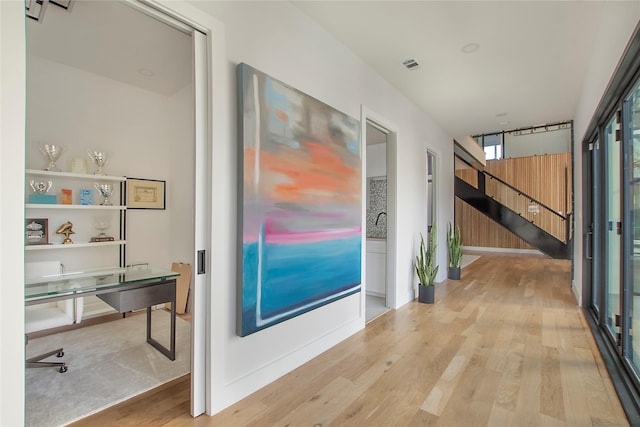 hall with light hardwood / wood-style floors