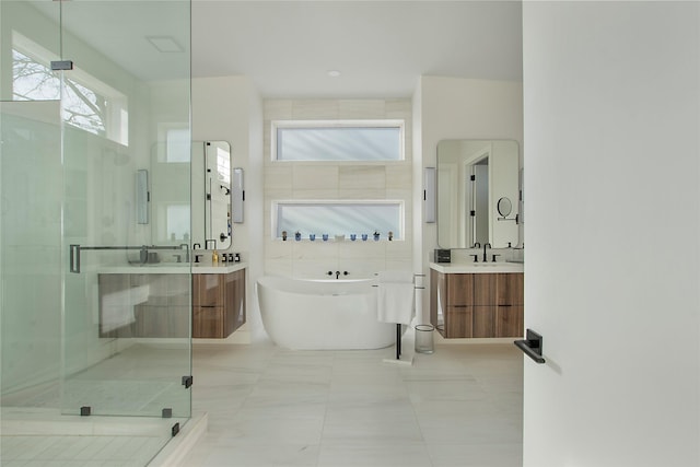 bathroom featuring vanity, tile patterned flooring, independent shower and bath, and tile walls