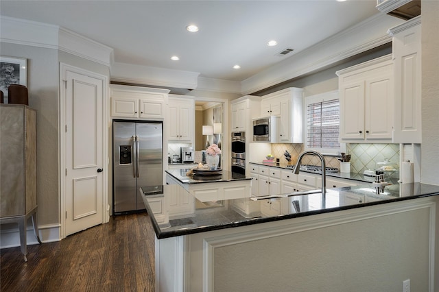 kitchen featuring stainless steel appliances, dark wood-type flooring, white cabinets, and kitchen peninsula