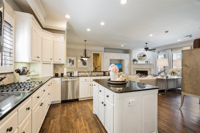 kitchen with pendant lighting, sink, white cabinets, and appliances with stainless steel finishes