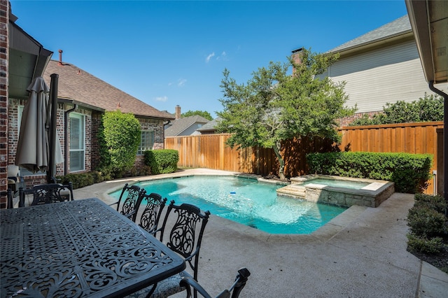 view of swimming pool featuring an in ground hot tub and a patio