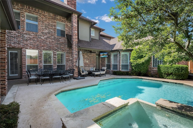 view of swimming pool with an in ground hot tub and a patio area